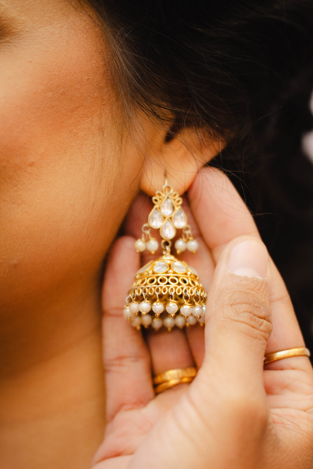 Gold jhumka earring detail