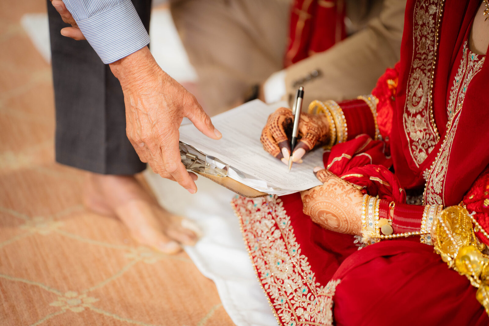 Bride signing the marriage documents